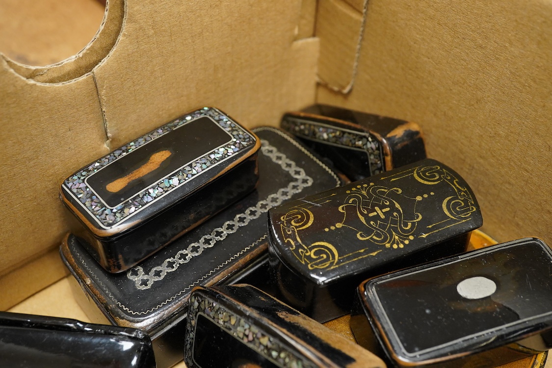 A collection of various snuff boxes to include papier mache examples, two with printed lids and some inlaid examples